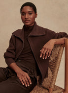 Varley Enrico Knit Jacket in Coffee Bean Model Sitting in a Chair