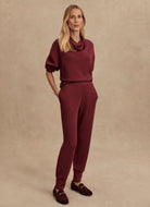 Varley The Slim Cuff Pant 27.5” in New Maroon Front View With Hands in Pockets