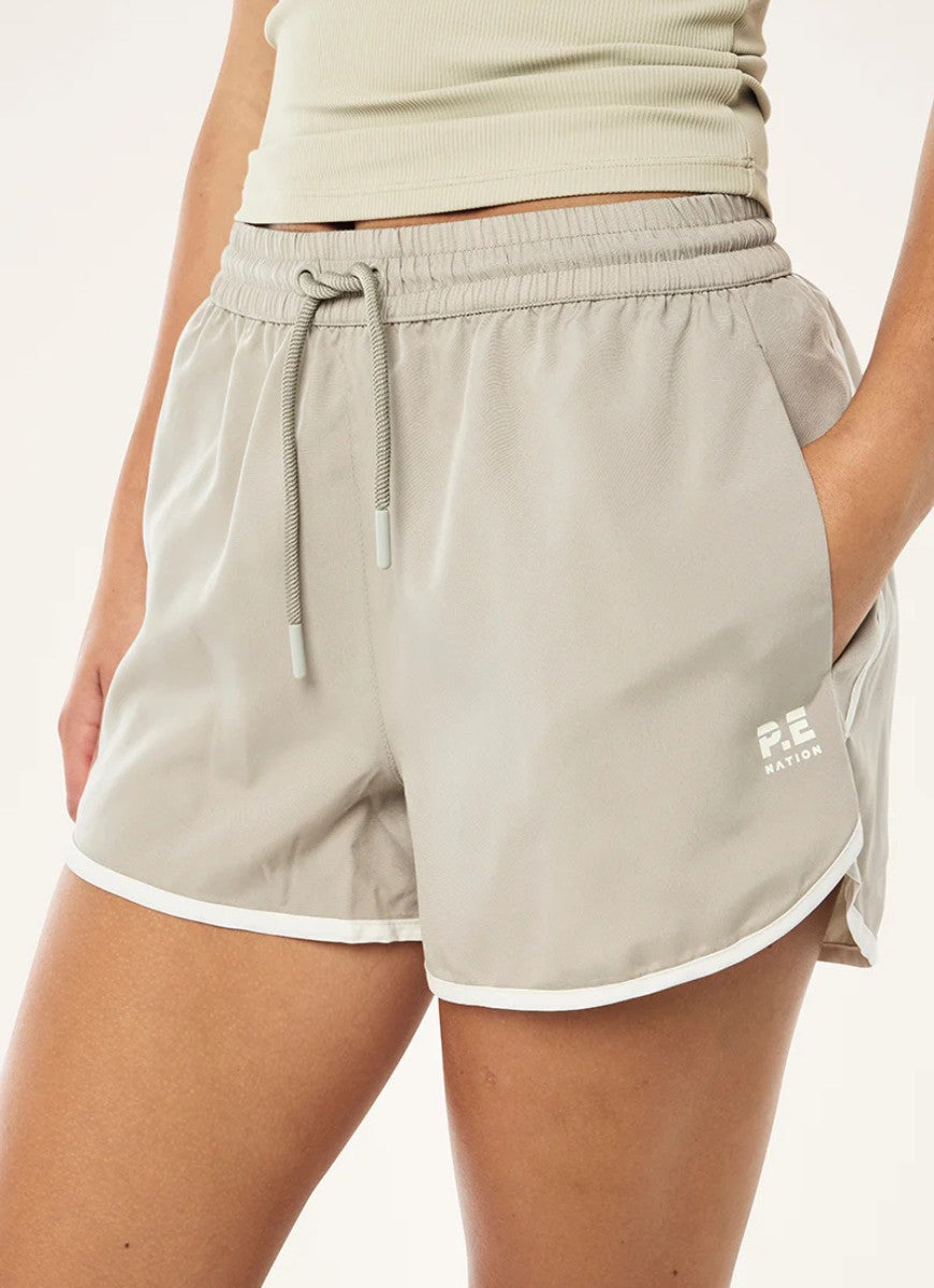 P.E Nation Academy Short in Biscuit Close Up Front View of Hand in Pocket