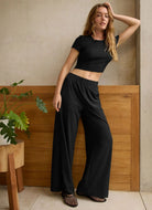 Beyond Yoga Easy Wide Leg Pant in True Black Front View With Model in a Pose