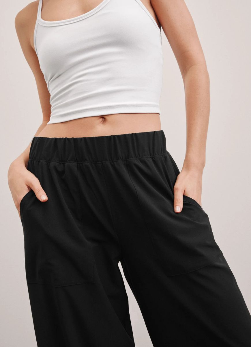 Beyond Yoga Easy Wide Leg Pant in True Black Close Up Front View With Hands in Pockets