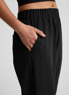 Beyond Yoga Easy Wide Leg Pant in True Black Side View Shown With Hand in Pocket