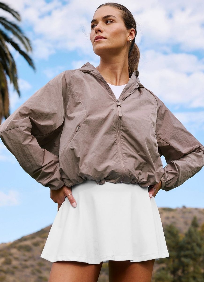 Beyond Yoga Limitless Hooded Jacket in Rosey Taupe Model Shown in Tropical Setting
