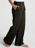 Beyond Yoga Status Wide Leg Trousers in Olive Ink Side View With Hand in Pocket