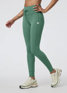 Vuori Daily Pocket Legging in Hedge Green Angled Front and Side View