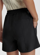 Varley Esmond Mid Rise Short 3” in Black Close Up Back View With Hand in Pocket