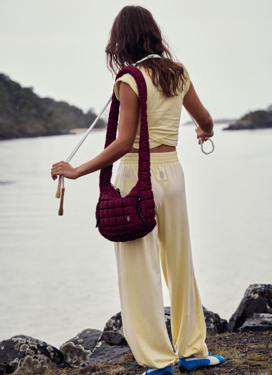 Free People Hot Shot Crossover Set in Sunlit Yellow Back View on Rocky Shoreline