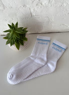 relevé Grip Socks in White with Blue Logo Two Sock View