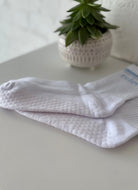 relevé Grip Socks in White with Blue Logo Close Up Showing Grips