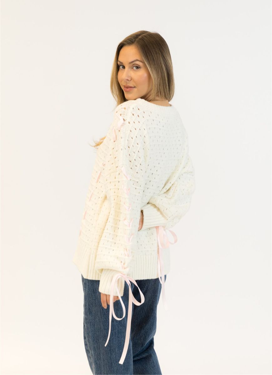Lyla + Luxe Lydia Crewneck Pullover Sweater in White/Pink Ribbon Back View With Model Looking Over Her Shoulder