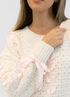 Lyla + Luxe Lydia Crewneck Pullover Sweater in White/Pink Ribbon Close Up Front View