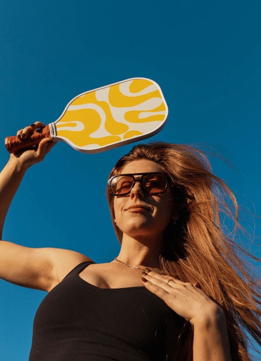 On Holiday Havana Pickleball Paddle Model Holding the Paddle Up in the Sky