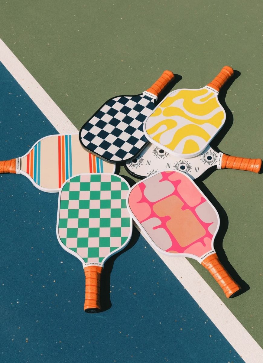 On Holiday Ibiza Pickleball Paddle 6 Shown Together Laying Flat on a Court