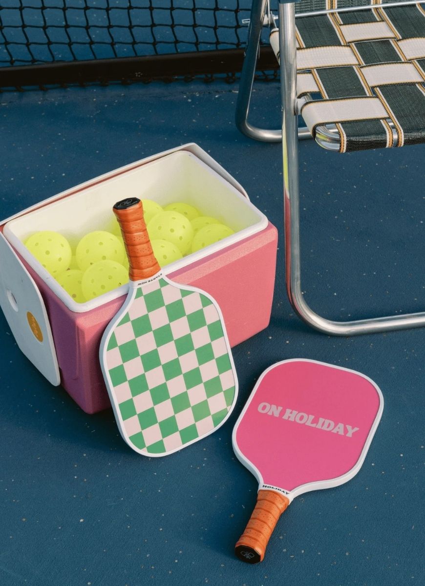 On Holiday Palma Pickleball Paddle Shown Together With Bin of Yellow Balls
