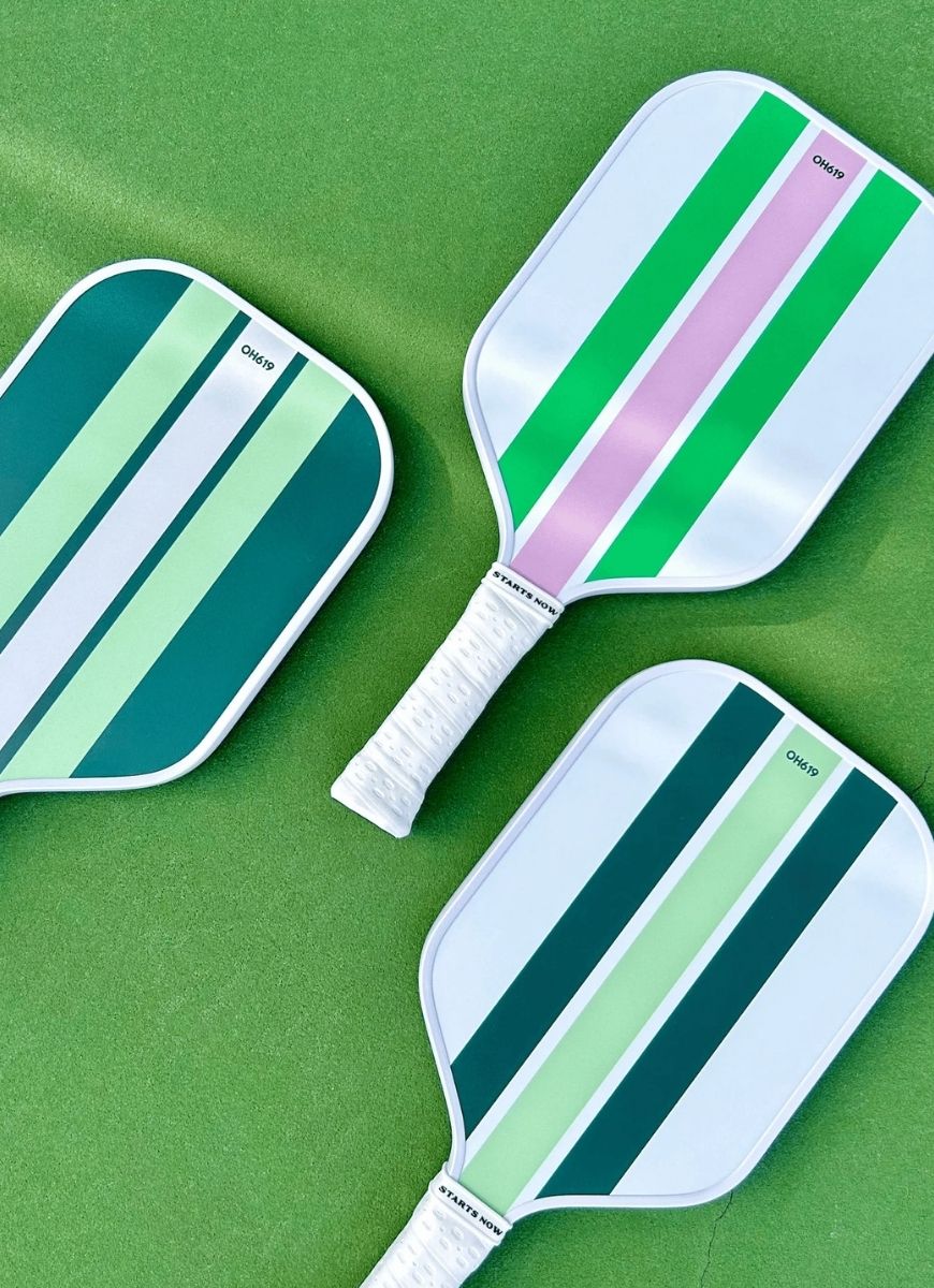 On Holiday Performance Lime Pickleball Paddle 3 Shown Together Laying Flat on Green Court