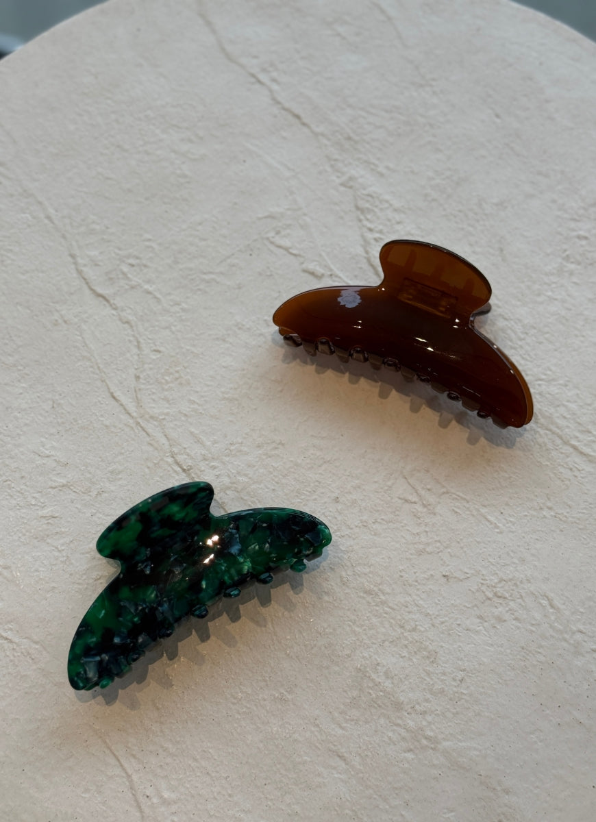 Claw Hair Clip in Clover Green Displayed on White Table