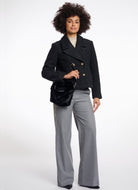 Rino & Pelle Cheryl Crossbody Bag in Black Model Shown Carrying Bag