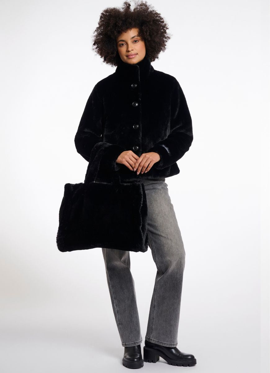 Rino & Pelle Daan Shopper Bag in Black Shown With Model Holding the Bag