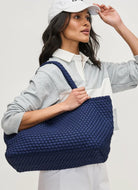 SOL AND SELENE Sky’s The Limit - Large Sustainable Tote Bag in Navy Side View Shown on Models Arm