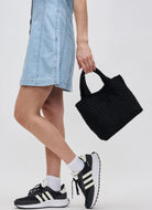 SOL AND SELENE Sky’s The Limit - Small Crossbody Bag in Black Model Showing Carrying Bag by the Handles