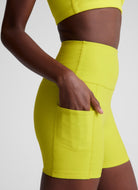 Beyond Yoga Spacedye Keep Pace 5" Pocket Short in Citrus Pop Heather Close Up Side View of Hand in Pocket
