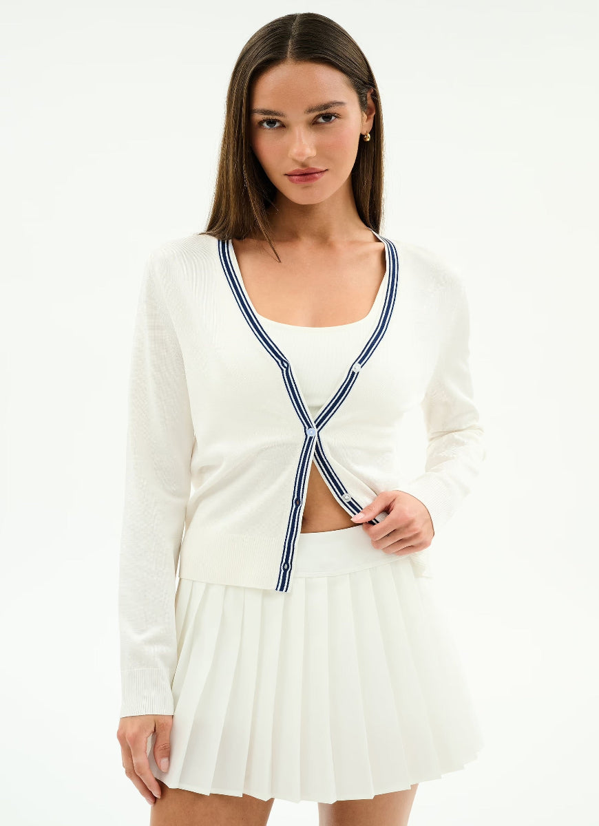 Woman wearing a white outfit with a blue trim on a white background