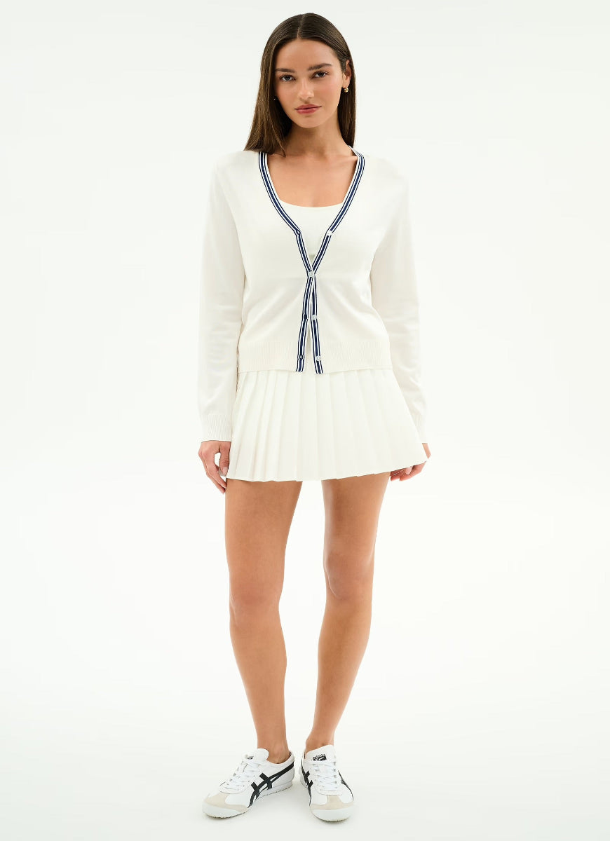 Woman wearing a white zip-up sweater dress on a white background