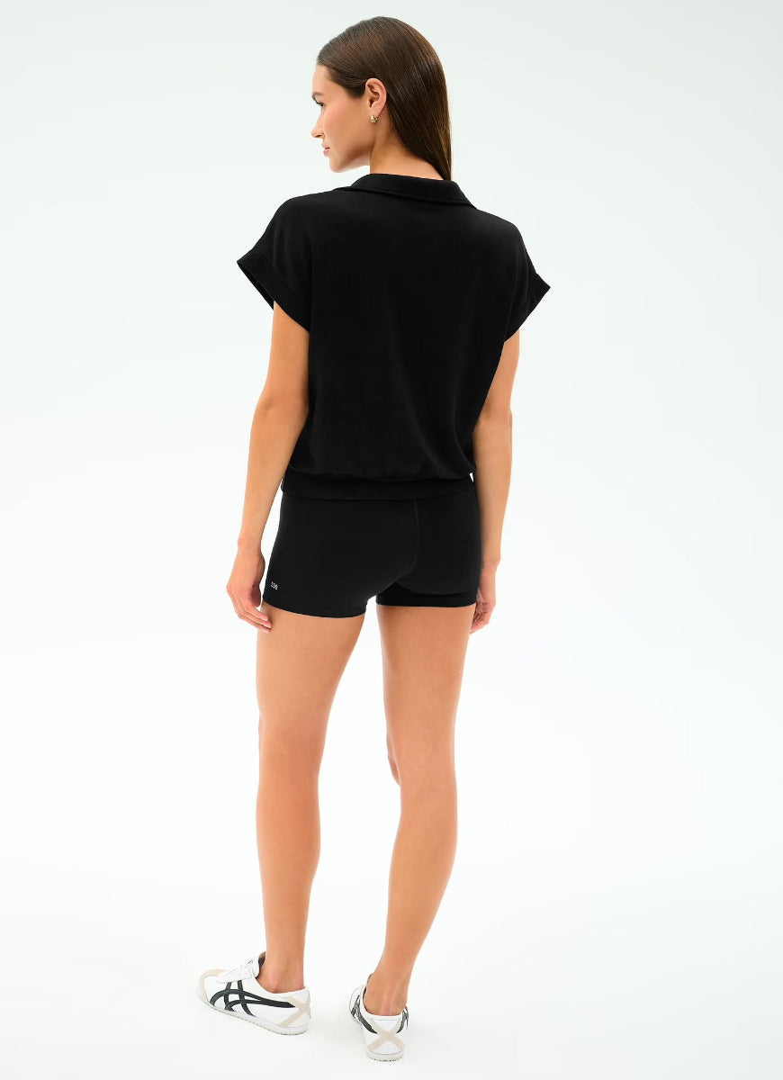Person wearing a black outfit on a white background
