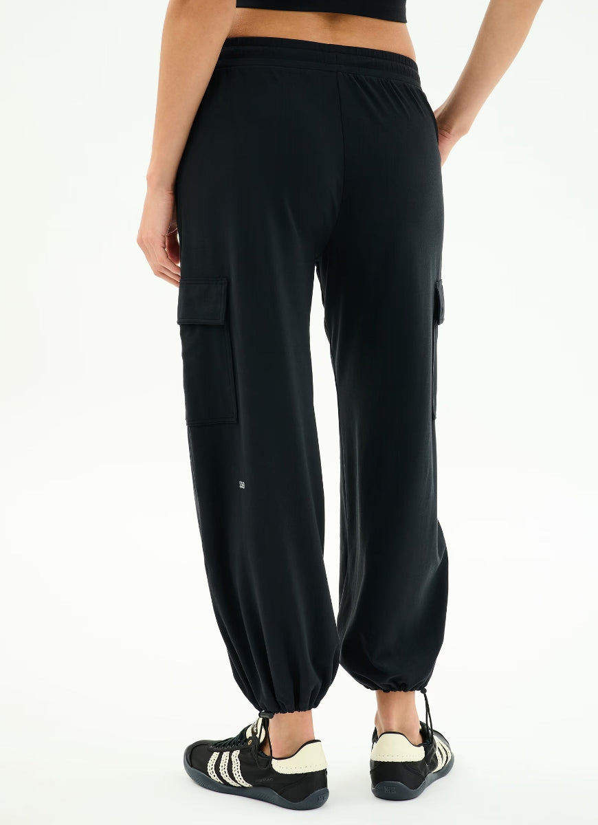 Black cargo jogger pants worn by a person on a white background