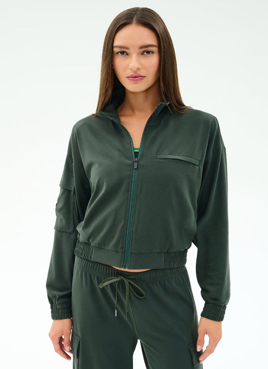 Woman wearing a green tracksuit on a white background