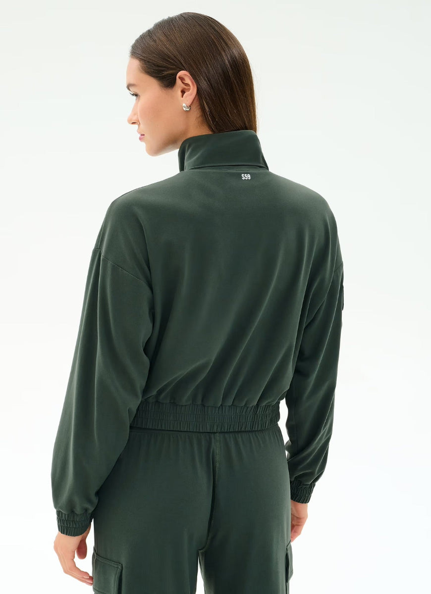 Person wearing a green tracksuit on a white background