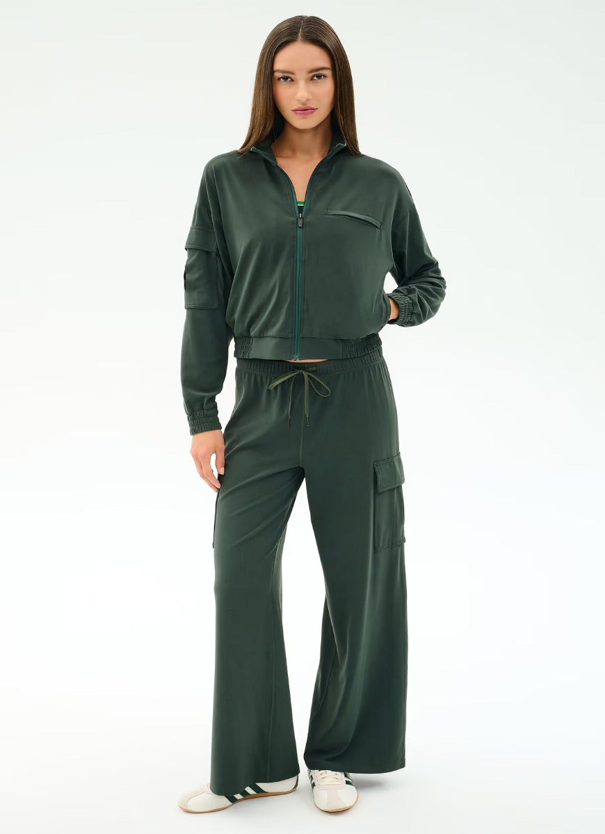 Woman wearing a green tracksuit on a white background
