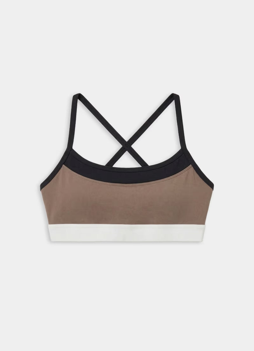Multicolored sports bra with criss-cross straps on a white background
