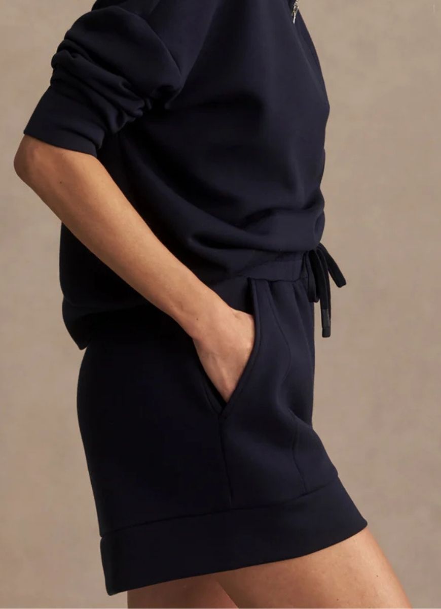 Varley Atrium High-Rise Short 4.5" in Navy Side View With Hand in Pocket