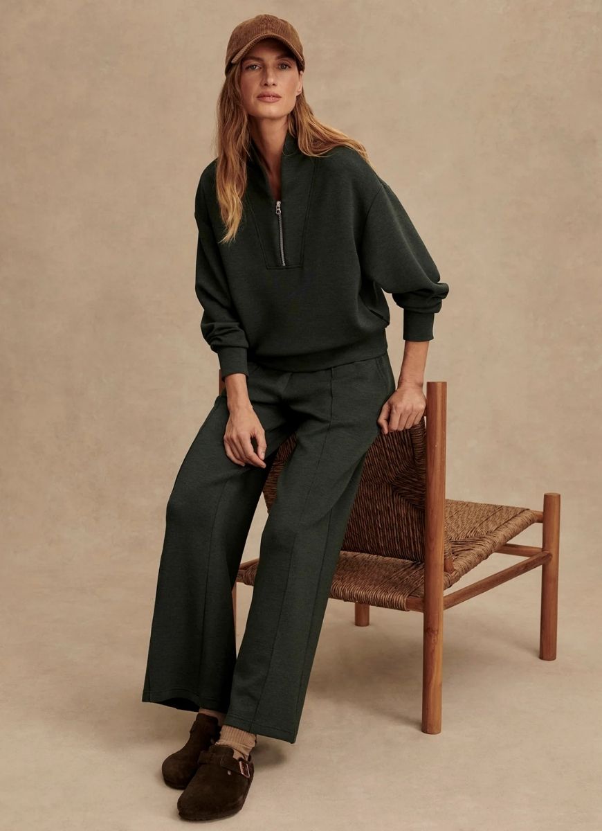 Varley Davidson Sweatshirt in Olive Marl Model Sitting on a Chair