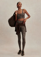 Varley Freesoft Cori Sports Bra in Brown Contrast Cheetah Front View Model Shown Carrying a Bag