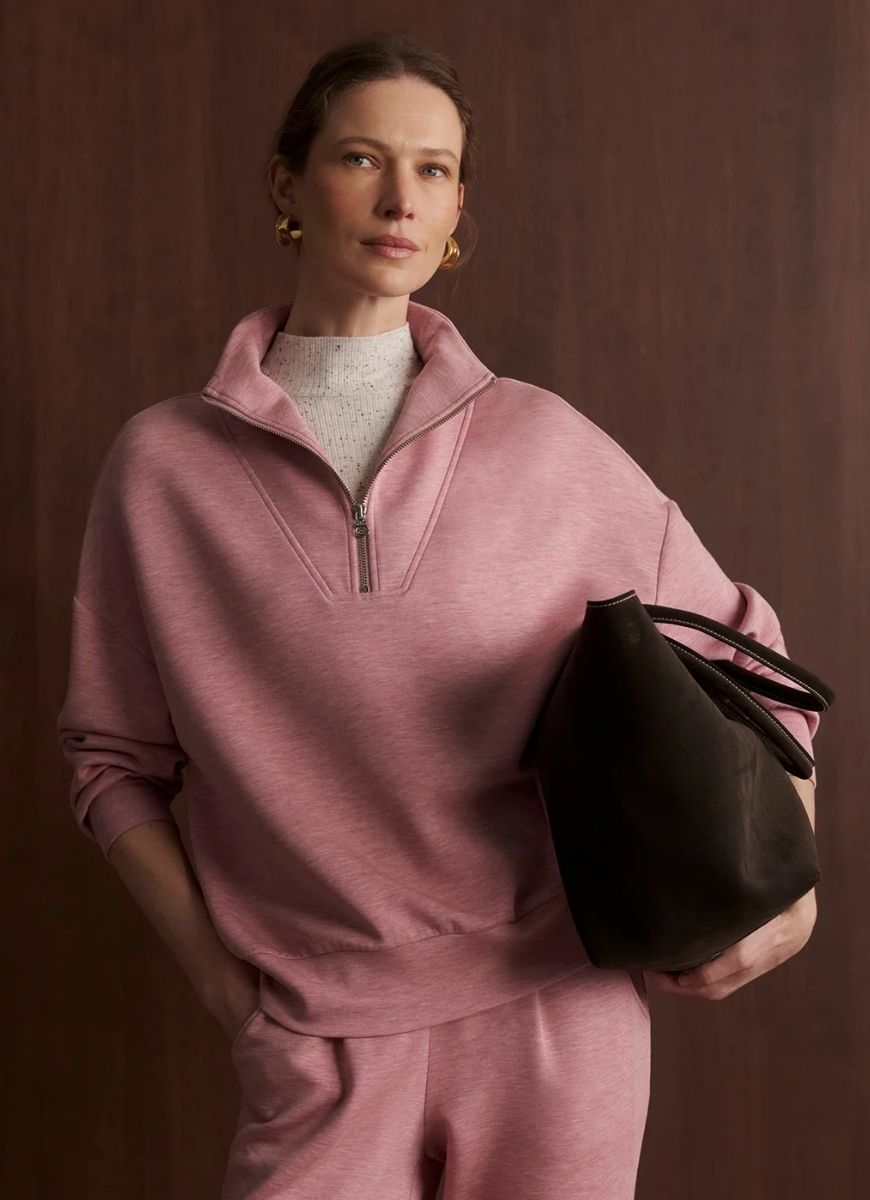Varley Hawley Half Zip Sweatshirt in Rose Marl Front View Shown With Model Holding a Bag