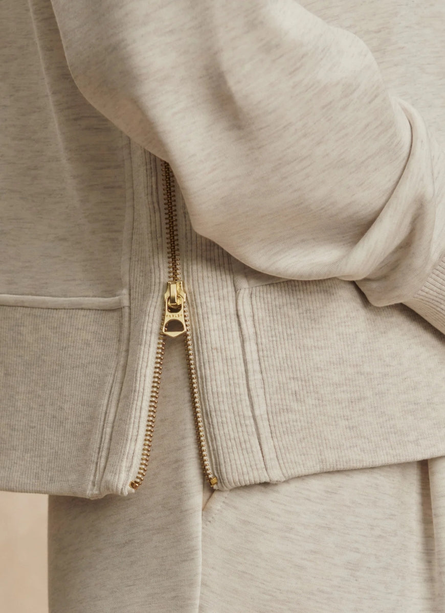 Varley Philippe Crop Sweatshirt in Ivory Marl Close Up View of Side Slit Zipper