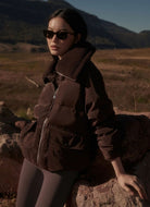 Varley The Roseville Down Jacket in Coffee Bean Model Shown Outdoors in the Mountains