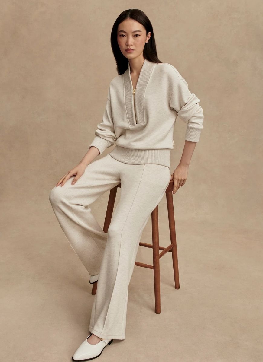 Varley The Wide Leg Pant 28” in Ivory Marl Model Sitting on a Stool