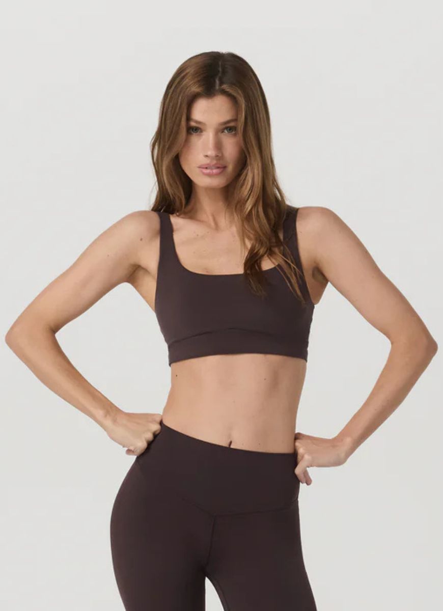 Vuori AllTheForm™ Sports Bra in French Roast Front View Showing Model With Hands on Hips