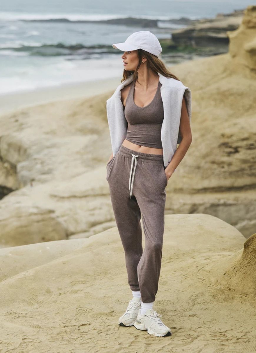 Vuori Halo Performance Crop 2.0 in Huckleberry Heather Full Length Front View With Model Posing on a Beach