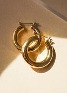 Luv AJ Baby Amalfi Tube Hoops Top Down View in the Sunlight