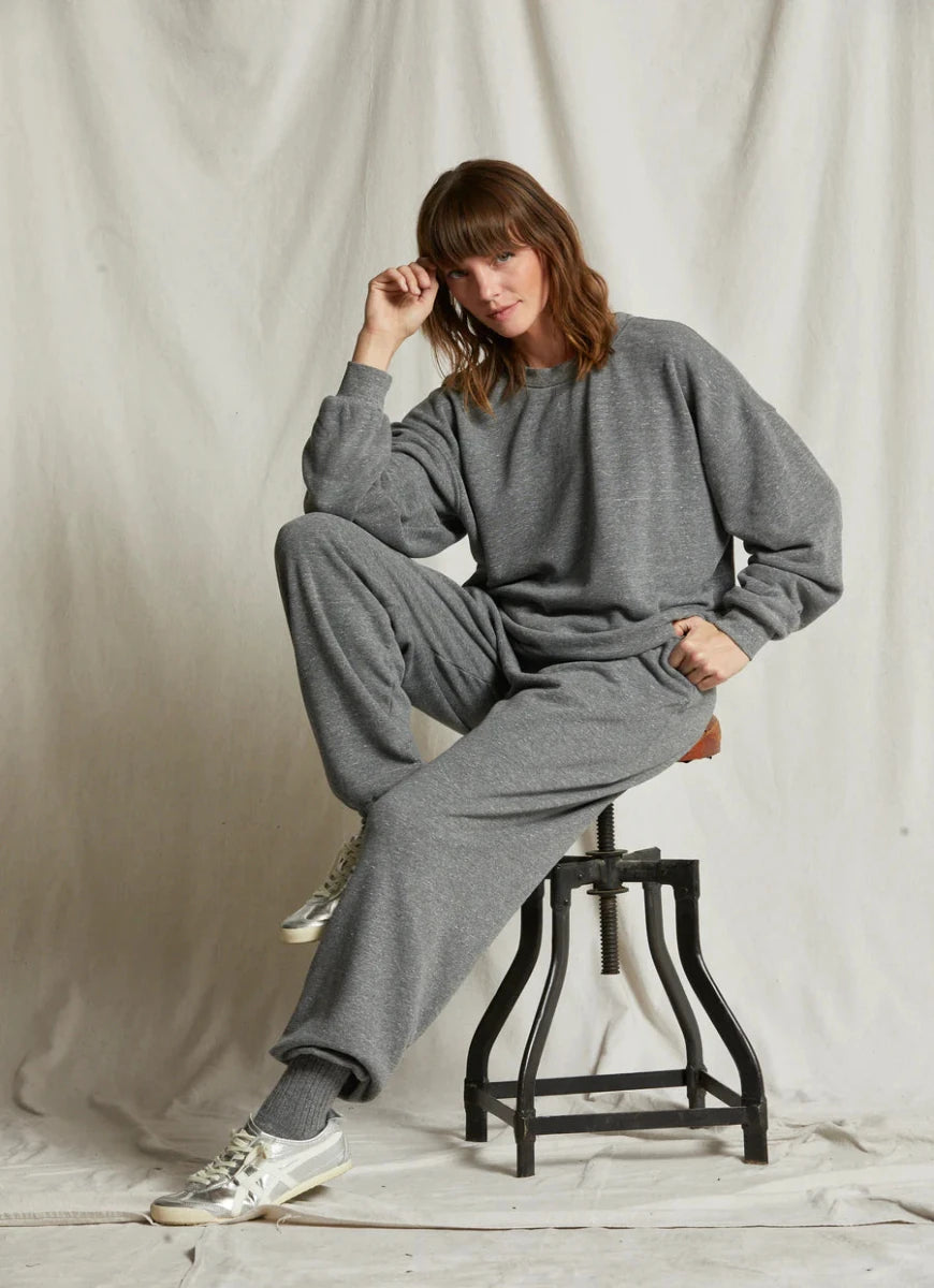 perfectwhitetee Women's Dre Fleece Jogger in Grey Heather Model Sitting on a Stool