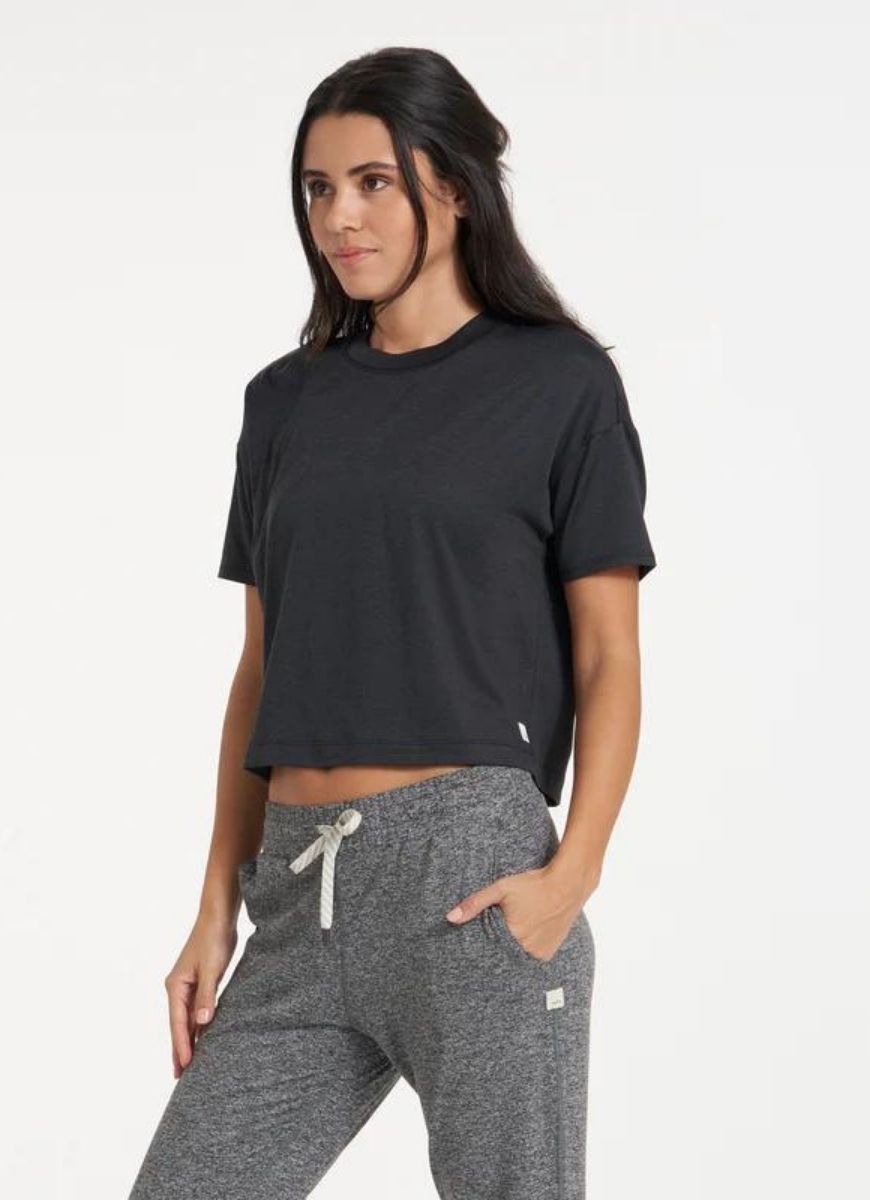 vuori Women's Energy Tee in Black Angled Side View with Hand in Pocket