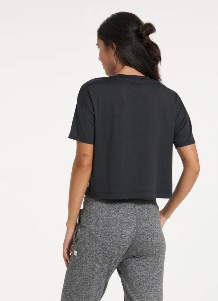 vuori Women's Energy Tee in Black Back View with Hand in Pocket