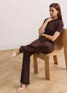 Lune Active Olly Regular Short Sleeve Tee in Chocolate Model Sitting on a Chair