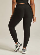 Beyond Yoga Out of Pocket High Waisted Midi Legging in Darkest Night Back View