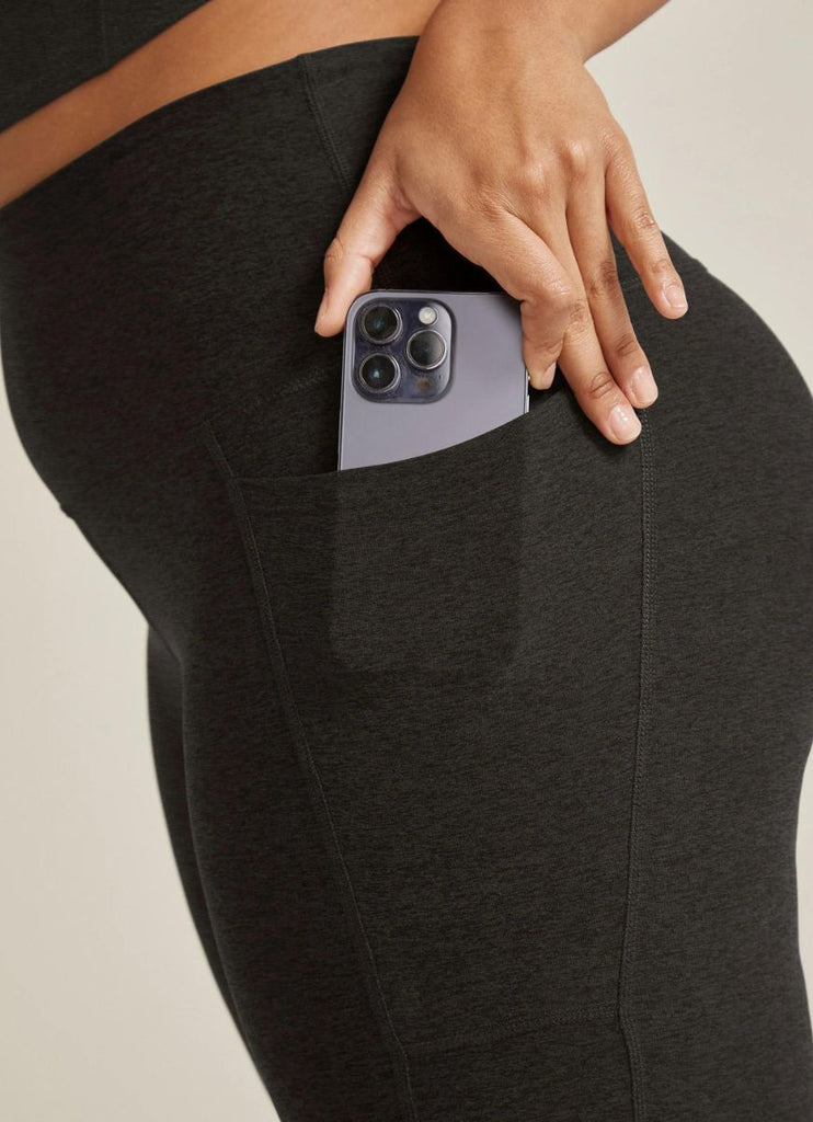 Beyond Yoga Out of Pocket High Waisted Midi Legging in Darkest Night Close Up View of Phone in Pocket
