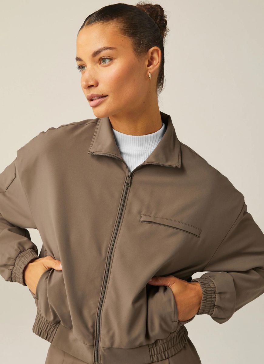 Beyond Yoga Status Pocket Sleeve Cropped Jacket in Dune Front View Zipped Up